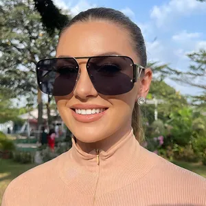 Chic oversized semi-rimless sunglasses with gradient black lenses and gold metal temples