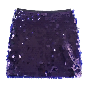 Close-up of sparkling purple sequins on a stylish mini skirt with a smooth texture