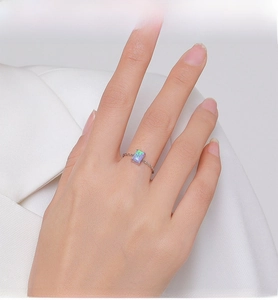 Detail of S925 silver ring with rectangular opal and elegant twisted rope band design