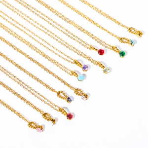 Detailed close-up of 12 gold titanium steel necklaces with colorful birthstone charms
