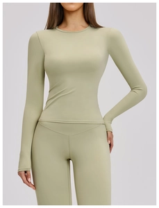 Detailed close-up of high-elasticity brushed fabric on a sage green yoga sports top