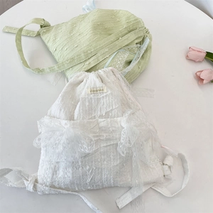 Detail of sweet floral lace drawstring backpack with ribbon bows and wavy texture fabric