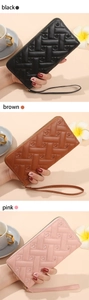 Detail of long quilted zip wallets with heart embossing in black, brown, and pink