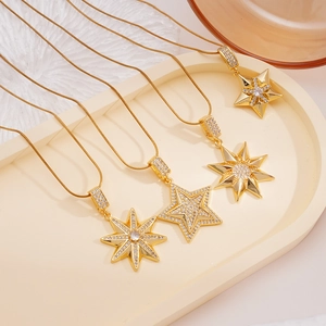 Gold plated snake chain necklaces with zircon star pendants on an oval display tray