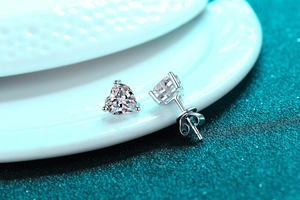 Macro view of heart-shaped S925 silver stud earrings with clear moissanite stones