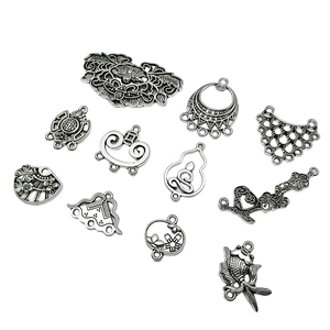 Antique silver alloy charms set with traditional Chinese motifs on white background