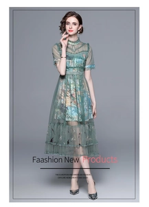 Close-up of elegant embroidery and polka dot mesh on the green A-line dress
