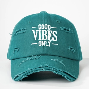Detail shot of Good Vibes Only embroidery on teal distressed cotton baseball cap