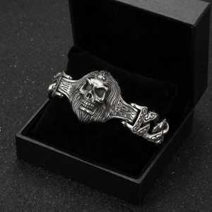 Detail of vintage punk skull bracelet with horseshoe link chain on black velvet box