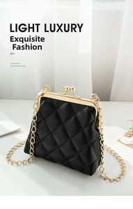 Detail of black quilted leather crossbody bag with vintage gold metal clasp and chain