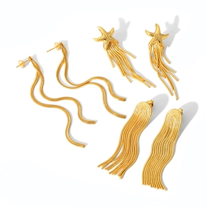 Detail shot of three pairs of gold tassel earrings including starfish and chain designs