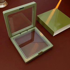 Close-up of olive green portable jewelry storage boxes with transparent suspension film