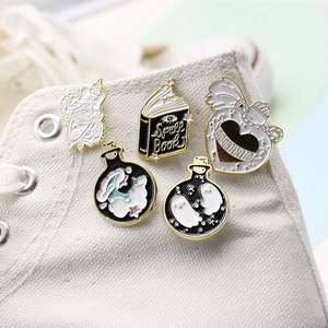 Ghost spell book and magic potion enamel pins set on white canvas shoe surface