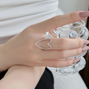 Elegant S925 sterling silver heart ring with micro-pave cubic zirconia on a model's hand