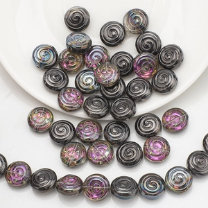 Macro detail of spiral texture glass beads in black and iridescent purple for DIY jewelry