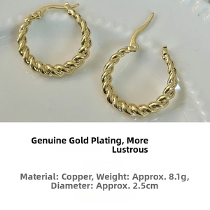 Detail view of twisted gold hoop earrings in copper, 2.5cm diameter and 8.1g weight
