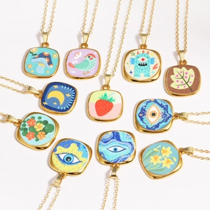 Detailed collection of vintage gold chains with colorful square enamel art pendants