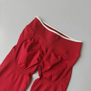 Detail of red high-waisted seamless yoga leggings with scrunch butt lifting texture