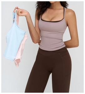 Detail view of high-waist yoga pants with side pockets and criss-cross waist design