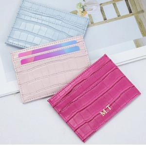 Detail of PU leather card holders with crocodile texture in blue, pink and rose gold