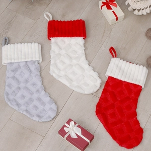Detail of Christmas stockings with diamond faux fur texture and hanging loops on wood