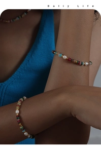 Detailed view of colorful beaded necklace and bracelet set with freshwater pearls on model