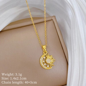 Detailed close-up of gold moon and star pendant with tiny crystals on a jewelry box