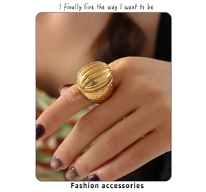 Detail of vintage gold-plated oval ring featuring vertical stripes and hammered texture