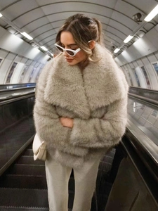 Close-up of fluffy faux fur texture and lapel design on this gray winter coat for women