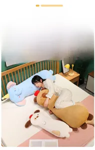 Close-up of soft long plush pillows in blue elephant, brown capybara, and white dog styles