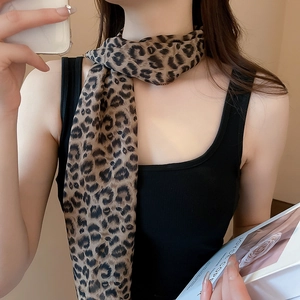 Close-up of lightweight leopard print silk scarf styled as a chic necklace accessory