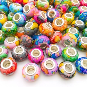 Detailed view of colorful ink painted resin beads with silver large hole metal core for DIY