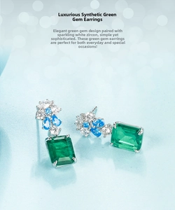 Detailed close-up of emerald-cut green gemstone earrings with blue zircon in S925 silver