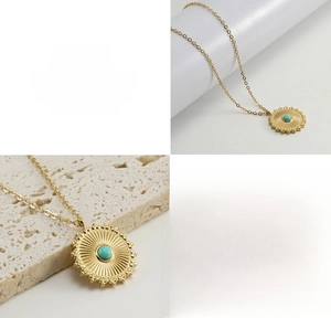 Detailed macro of a 18k gold sunburst pendant with turquoise inlay on titanium steel chain