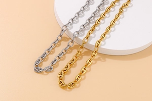 Detailed view of gold and silver stainless steel anchor link chains with a metallic finish