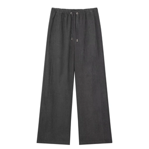 Detail of dark grey wide-leg trousers featuring adjustable drawstring elastic waist and pockets