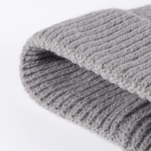 Deep grey knitted beanie hat for winter warmth with thick texture and foldable cuff design