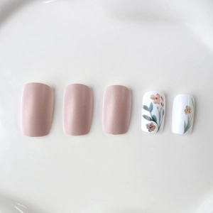 Floral press-on nails with pearlescent pink finish and elegant botanical leaf patterns