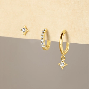 Detail of S925 sterling silver gold earrings set featuring star motifs and clear zircons