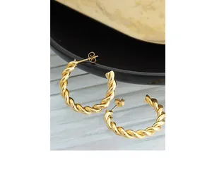 Close-up of twisted rope texture and polished 18K gold finish on C-shaped hoop earrings