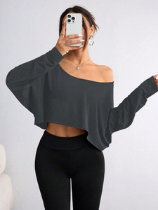 Close-up of charcoal grey off-shoulder cropped top showing fitted knit texture