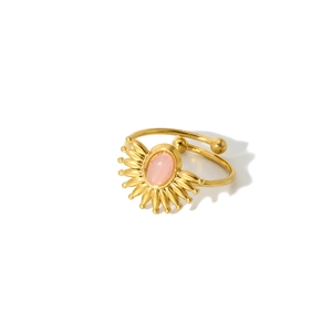 Detail of 18k gold plated ring featuring a pink gemstone and sunburst star design