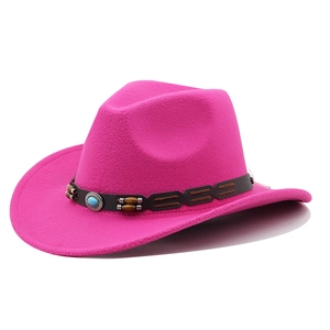 Detail of rose red wool cowboy hat featuring turquoise buckle and dark leather band