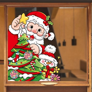 Christmas window decals with Santa, snowman and reindeer on glass in cozy cafe setting