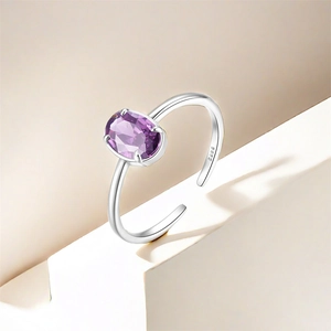 Detail of adjustable S925 sterling silver ring with oval purple zircon in four-prong setting