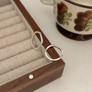 Minimalist 925 sterling silver streamline open rings set on a wooden jewelry box