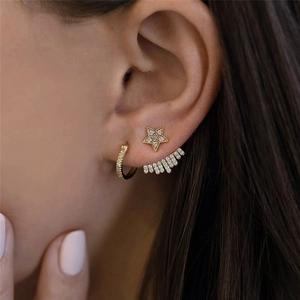 Detailed view of S925 silver gold star stud earring with a shimmering cubic zirconia jacket
