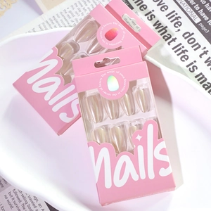 Two boxes of almond shaped pink aurora chrome press-on nails on a ceramic tray
