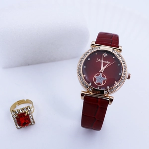 Close-up of a burgundy leather watch with rhinestone bezel and matching ruby ring set