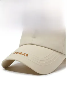 Close-up of beige baseball cap brim with brown NY&JA embroidery and reinforced stitching